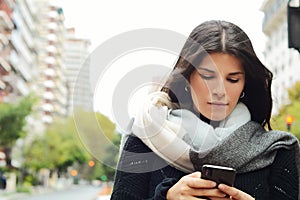 Young women sending message with smartphone.