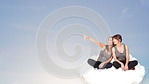 Young women sitting on cloud with copy space