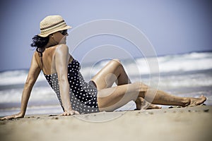 Young women sitting and relaxing on the pristine tropical beach