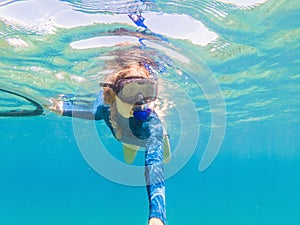 Young women at snorkeling in the tropical water