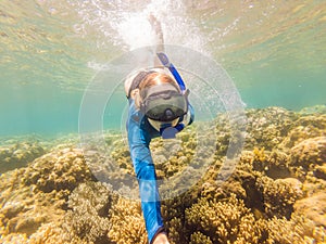 Young women at snorkeling in the tropical water