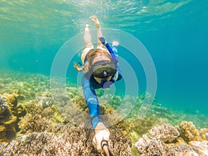 Young women at snorkeling in the tropical water