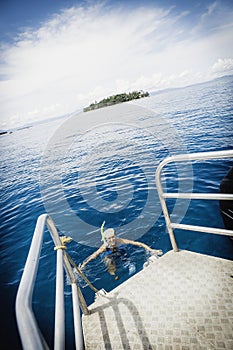 Young women is snorkling in the tropical ocean photo