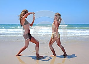 Young women on sunny beach