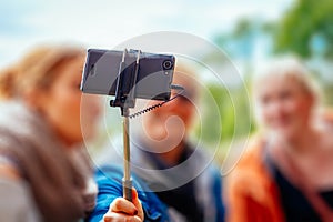 Young women taking a photo with a selfiestick