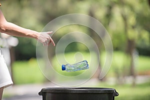 Young women throwing away bottle plastic