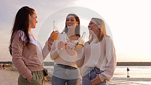 Young women toasting non alcoholic drinks on beach