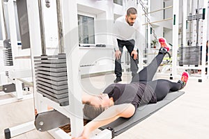 Woman working with personal trainer at gym