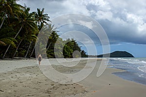 young women walking on the beach in Cape Tribulation in Daintree National Park in the far tropical north of Queensland, Australia