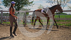 young women walking a brown horse