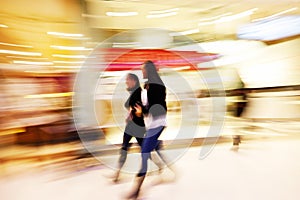 Young women walking past shop front window