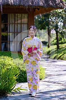 Young women wearing traditional Japanese kimono or yukata is happy and cheerful in the park