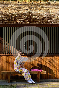 Young women wearing traditional Japanese kimono or yukata is happy and cheerful in the park