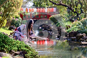 Young women wearing traditional Japanese kimono or yukata is happy and cheerful in the park