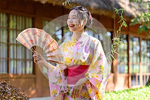 Young women wearing traditional Japanese kimono or yukata is happy and cheerful in the park