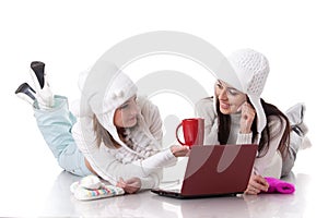 Young women in winter clothes with laptop