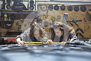 young women working in a mechanic shop