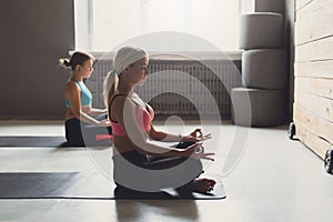 Young women in yoga class, relax meditation pose