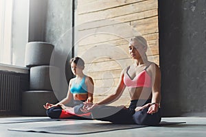 Young women in yoga class, relax meditation pose