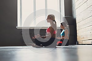 Young women in yoga class, relax meditation pose