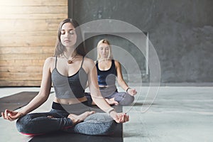 Young women in yoga class, relax meditation pose