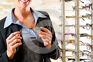 Young womman at optician with glasses