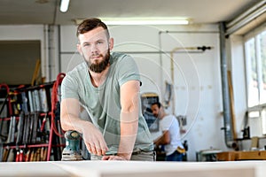 Young worker in a carpenters workshop