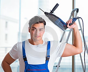 Young worker with hand drill