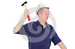 Young worker nailing with hammer photo