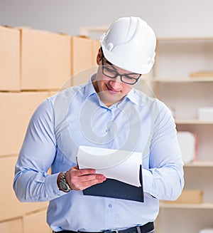 Young worker in the postal office dealing with parcels