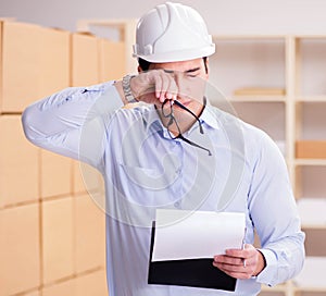 Young worker in the postal office dealing with parcels