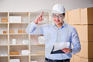 The young worker in the postal office dealing with parcels