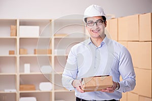 The young worker in the postal office dealing with parcels