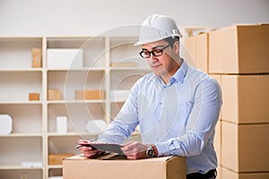 The young worker in the postal office dealing with parcels