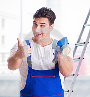 Young worker with protective face gas mask