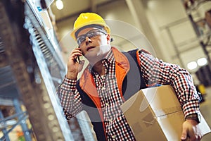 Worker In Warehouse Preparing Goods For Dispatch