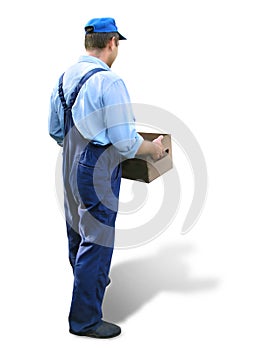 Young worker in working clothes, carrying a box. Looked from behind