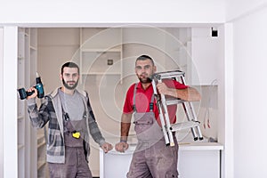 Young workers installing a new kitchen