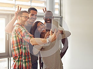 Young workers taking self portrait with phone