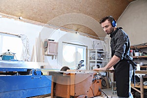 Young working man using circular saw