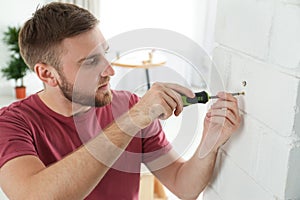 Young working man using screwdriver