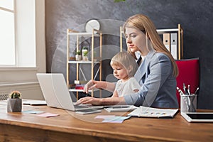 Young working mother spending time with baby