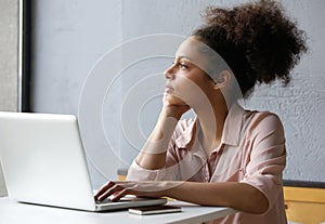 Young working woman looking out window