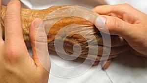 Young worried man holding and gently stroking hand of his sick mother showing care or love. Son comforting wrinkled arm