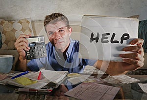 young worried man in stress at home calculating month tax expens