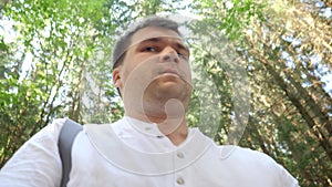 Young worried or scared man filming himself running out of the danger in forest