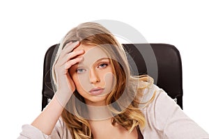 Young worried woman sitting at the desk