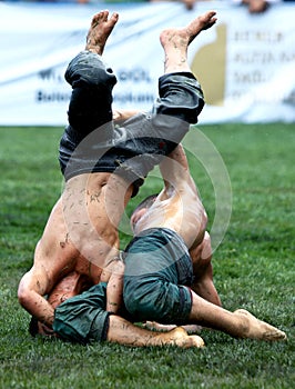 A young wrestler is overpowered by his opponent at the Kemer Turkish Oil Wrestling Festival in Turkey.