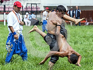 A young wrestler raises his opponent skywards during competition at the Kirkpinar Turkish Oil Wrestling Festival in Edirne in Turk
