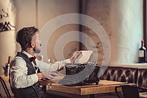 Young writer with a typewriter indoors